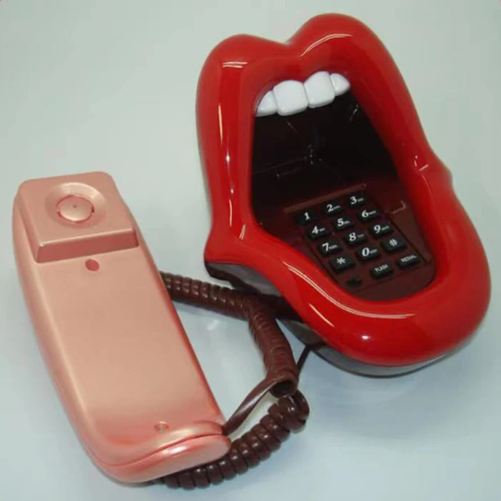 Retro novelty landline phone shaped like bright red lips with white teeth and a detachable metallic pink handset.