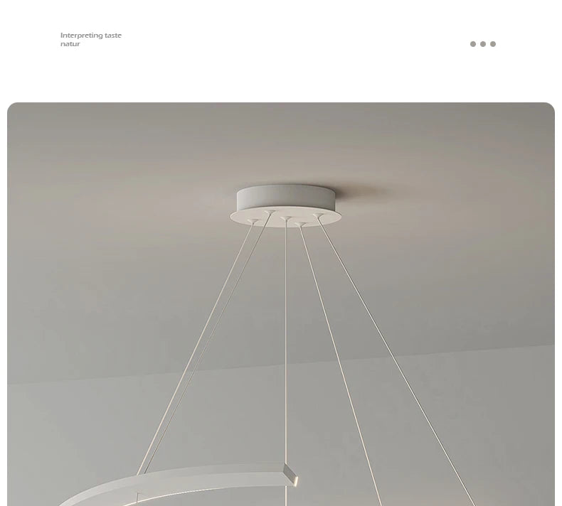 Minimalist white modern pendant lamp with thin suspension cables attached to a circular ceiling mount.