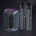 Dark grey portable Bluetooth speaker with top-ring purple lighting and two matching cordless karaoke microphones.