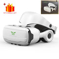 White and black VR headset with attached head strap and built-in adjustable earcups.