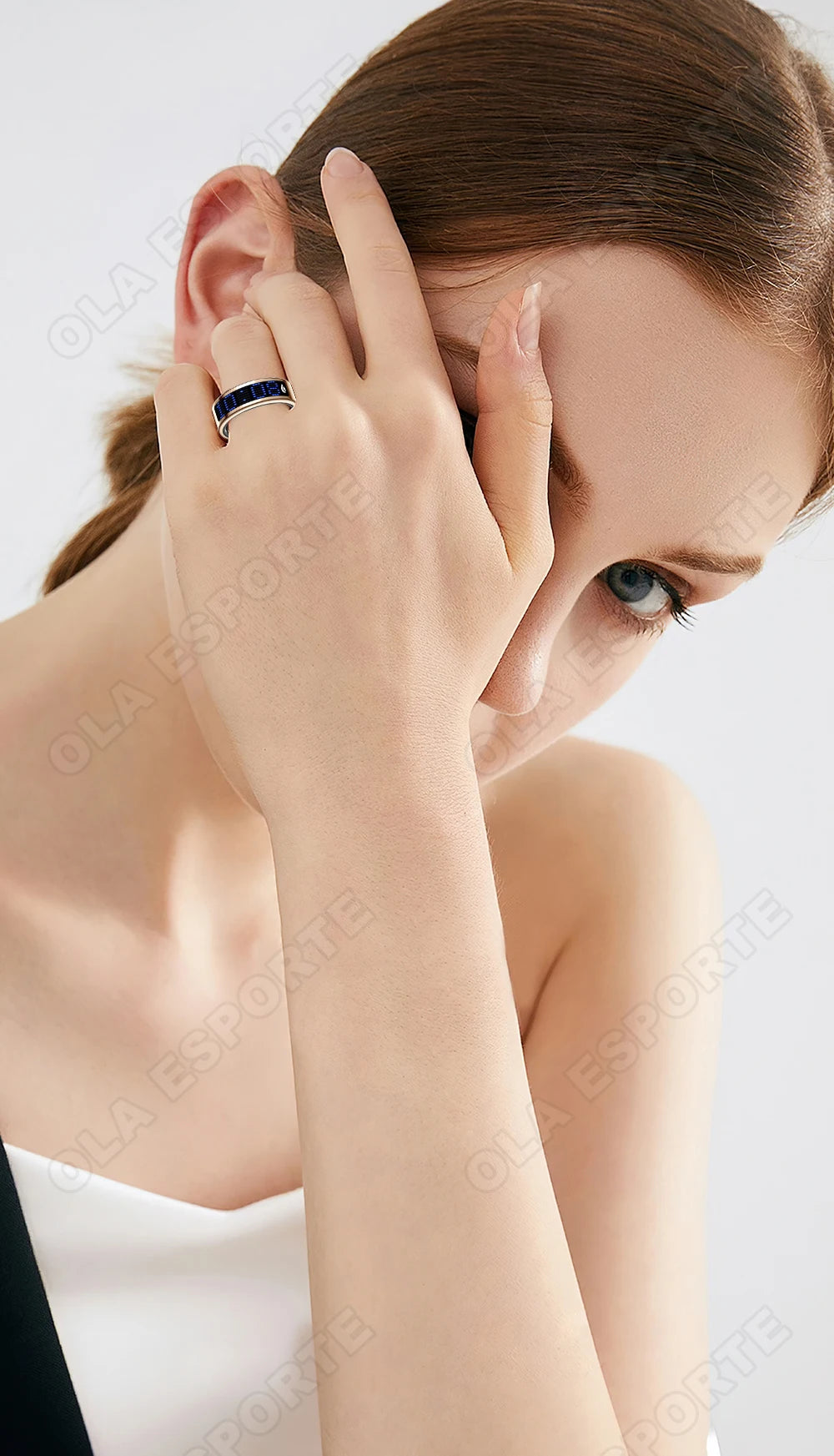 Elegant silver and dark blue smart fitness tracking ring worn on a woman's finger, showcasing a sleek, modern design.