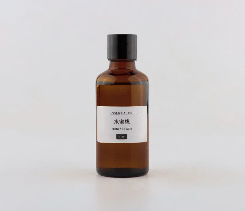 Amber glass 50ml essential oil bottle with a black cap and a label reading "Honey Peach".