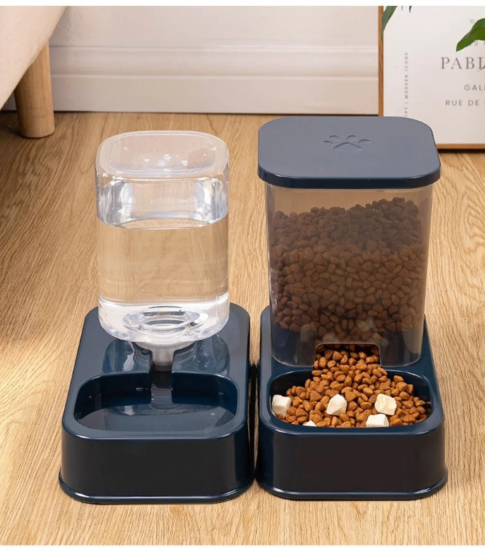 Automatic pet water dispenser and dry food feeder set in navy blue plastic with a transparent reservoir.