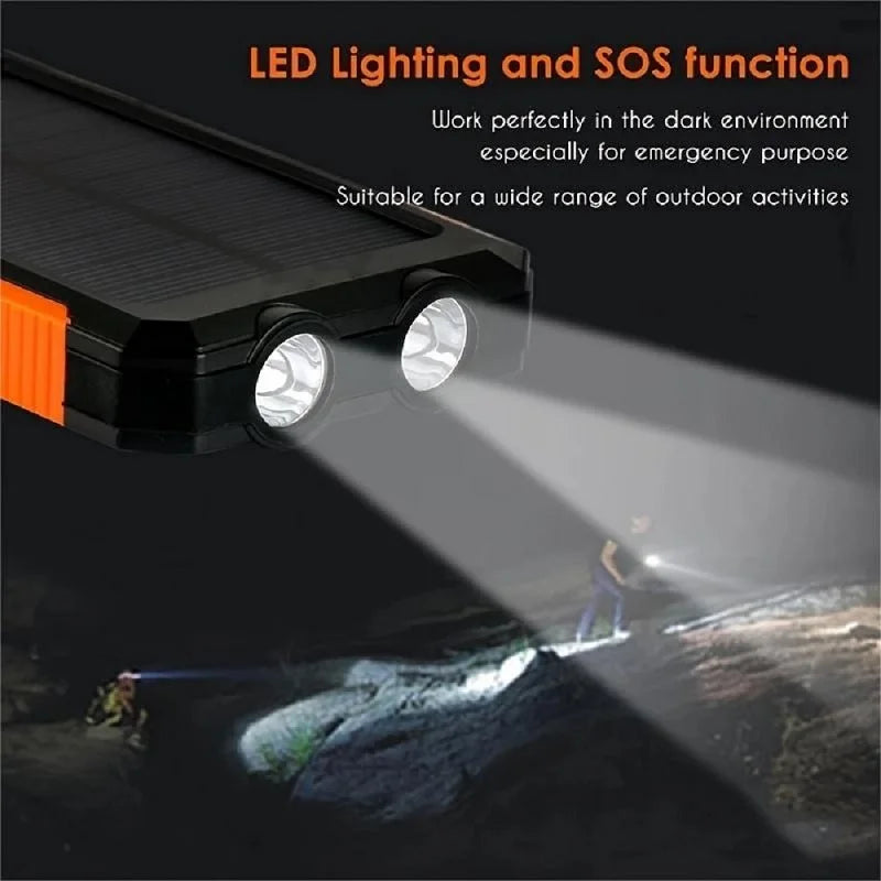 Black and orange solar power bank featuring dual LED torches shining a bright light on an outdoor trail.