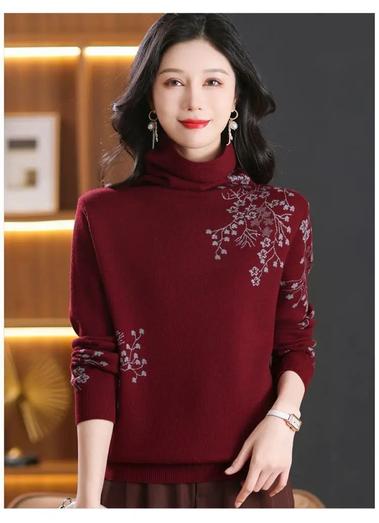 Burgundy high-neck sweater with long sleeves and delicate grey floral embroidery detail.