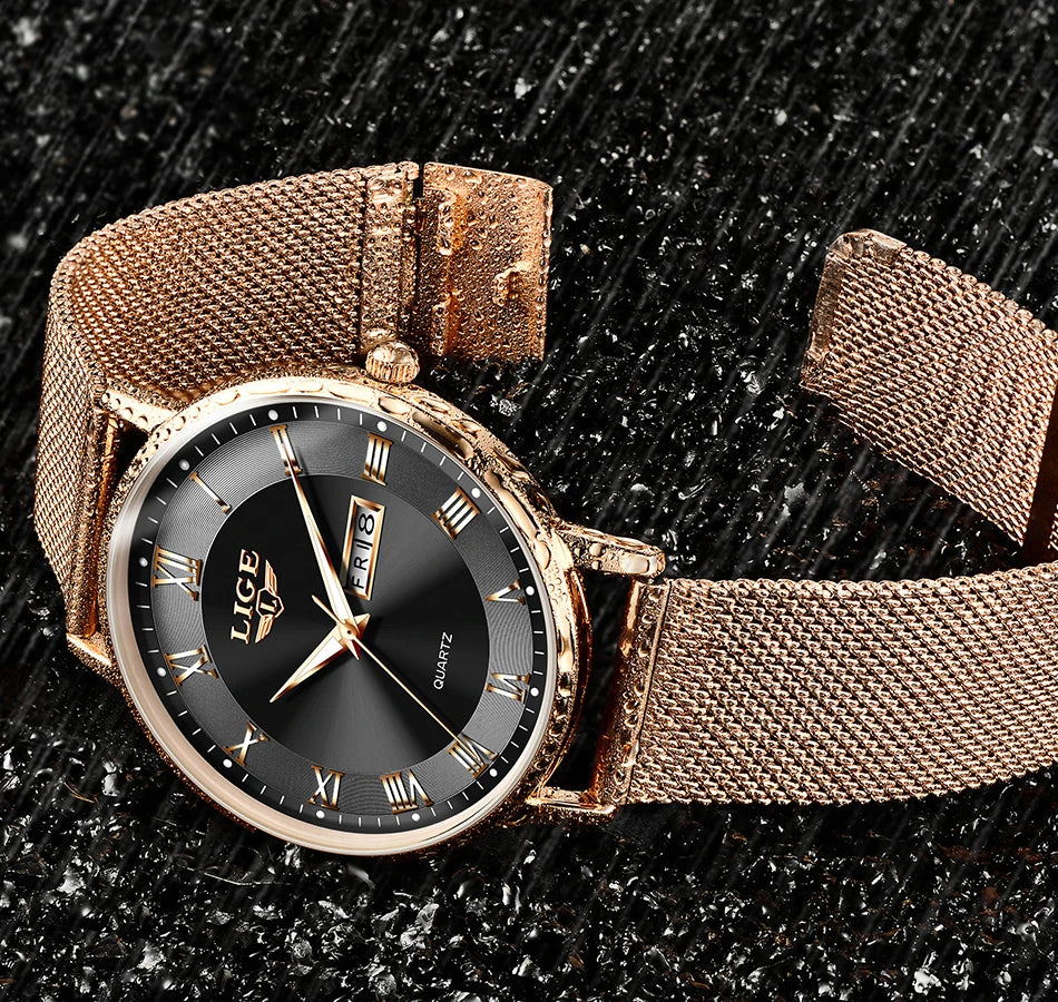 Elegant rose gold-tone women's watch with a mesh strap, black dial, Roman numerals, and a day-date display.