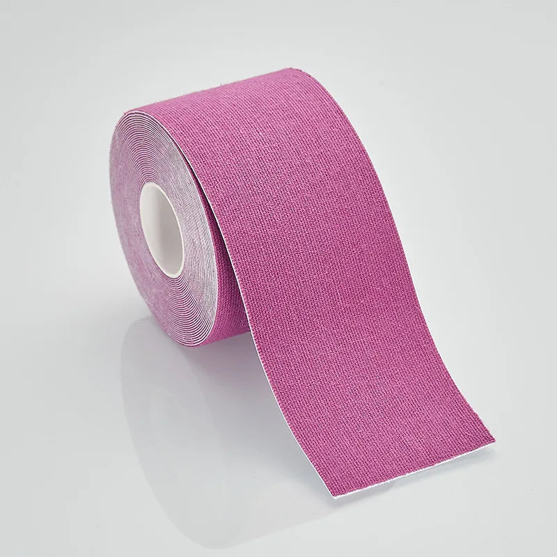 A roll of bright pink kinesiology sports tape on a plain white background.