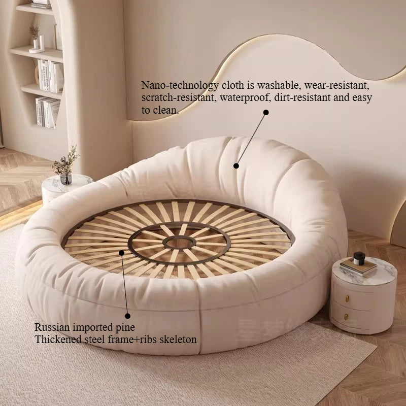 Modern round minimalist bed frame in cream fabric with a sturdy steel and wooden slatted base.