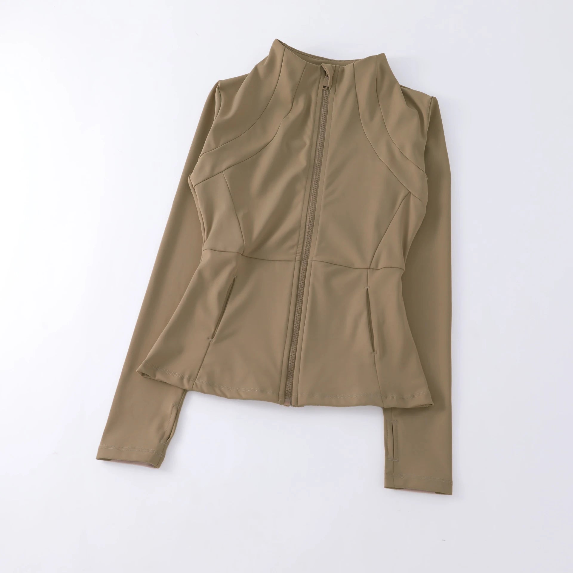 Beige long-sleeved athletic zip-up jacket with a high neck, fitted silhouette, and thumbhole cuffs.