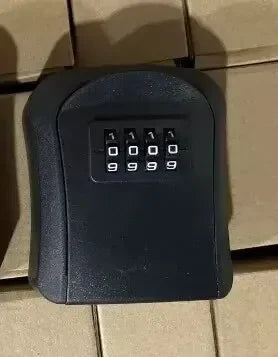 Black metal wall-mounted key lock box with a four-digit resettable combination dial.