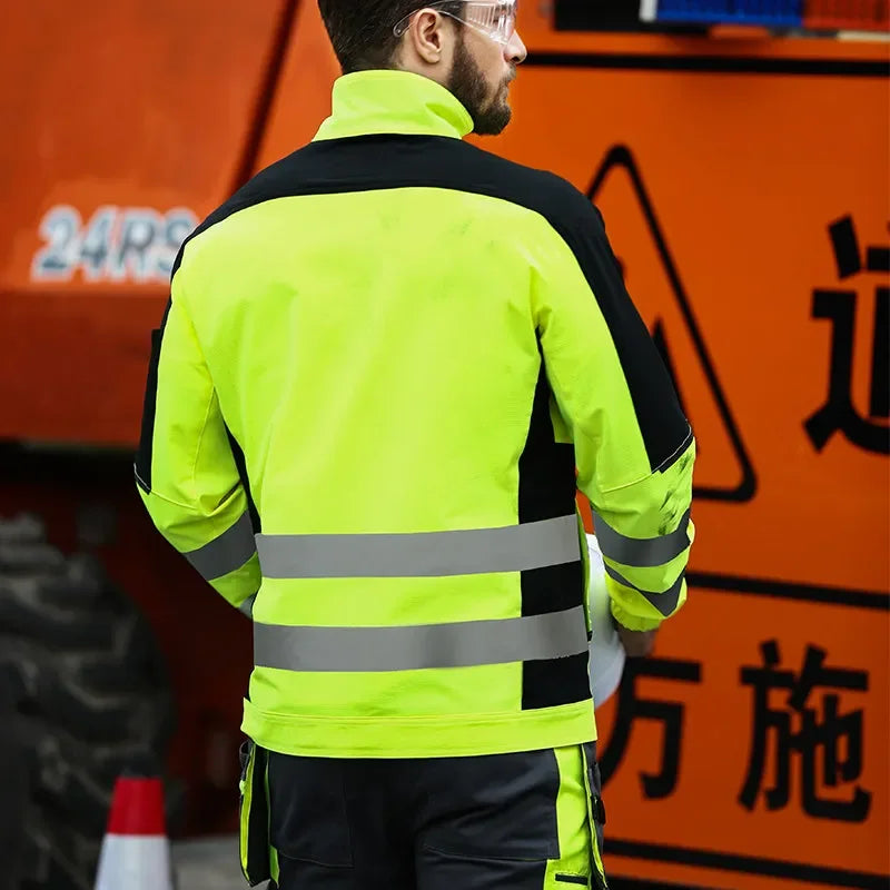 High-visibility neon yellow and black work jacket with reflective strips on the back, worn by a man at a construction.