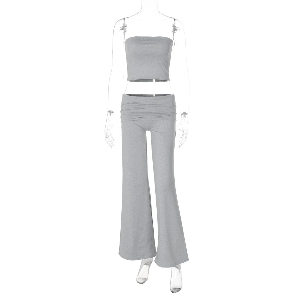 Grey two-piece set featuring a strapless crop top and high-waisted, flared trousers with a gathered waistband.