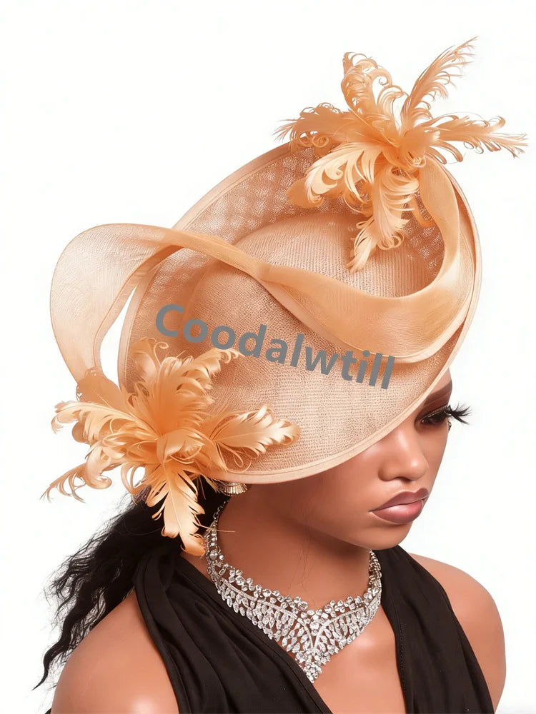 Elegant champagne-coloured fascinator hat featuring delicate feathers, stiffened mesh loops, and a wide-brim design.