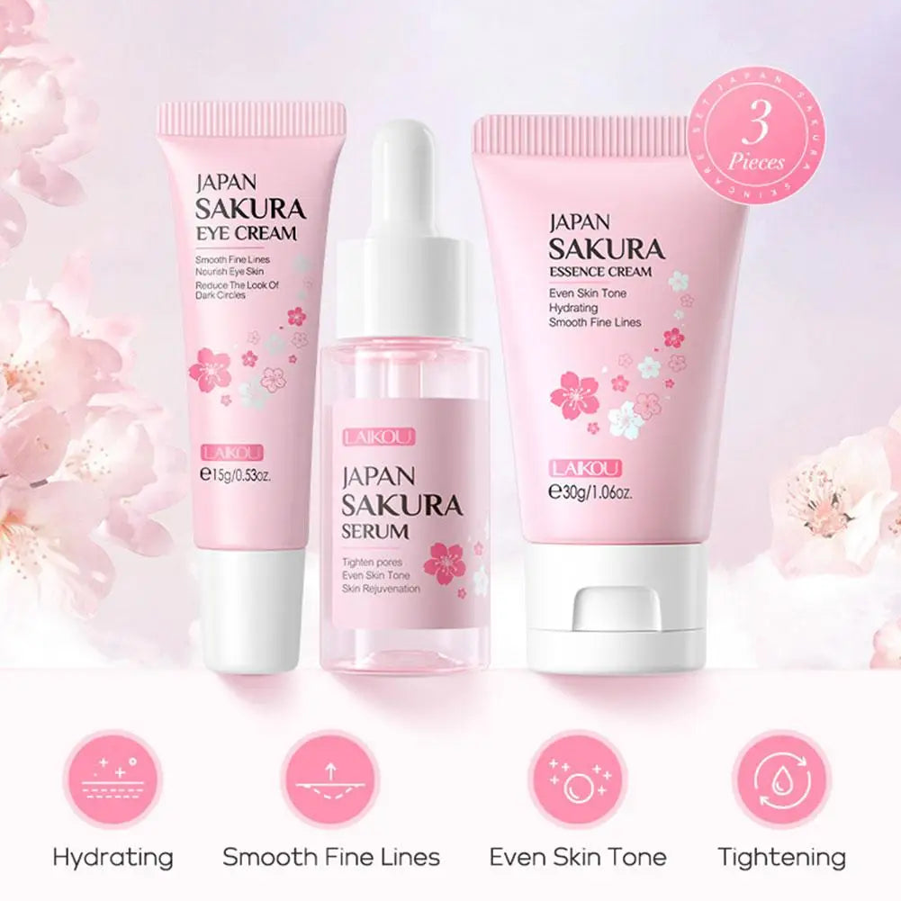 Three-piece Sakura skincare set featuring an eye cream, serum, and essence cream in soft pink packaging.