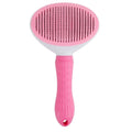 A pink and white pet slicker brush with a textured handle and fine bristles for grooming.