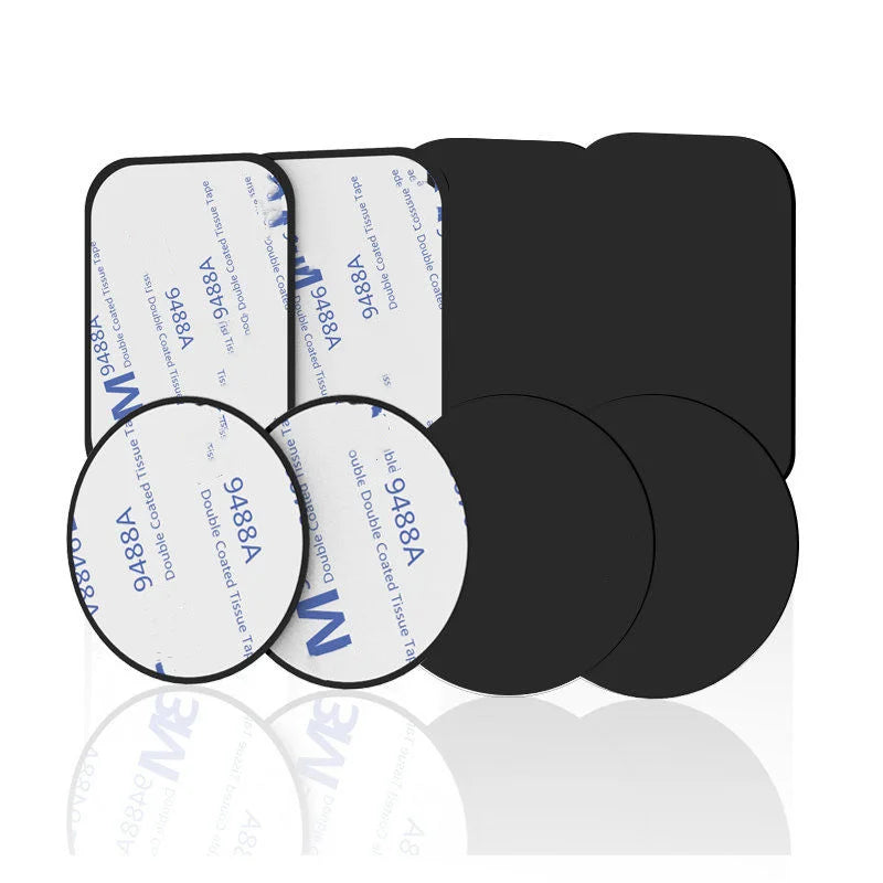 A collection of black rectangular and circular double-sided adhesive pads with white peel-off paper backings.