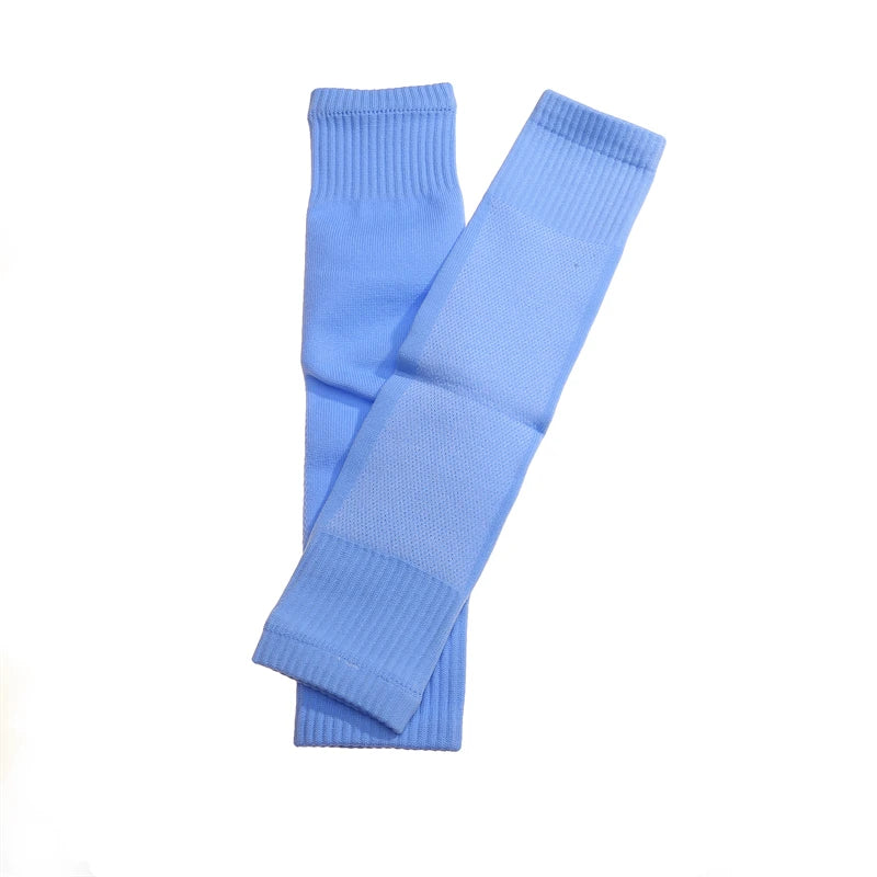 Pair of light blue sports compression calf sleeves with ribbed cuffs and textured, breathable fabric panels.