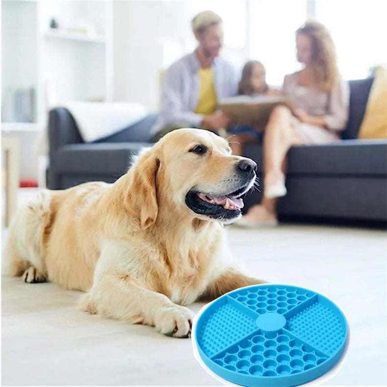 Blue circular silicone dog slow feeder bowl with a textured, multi-patterned design resting on the floor.