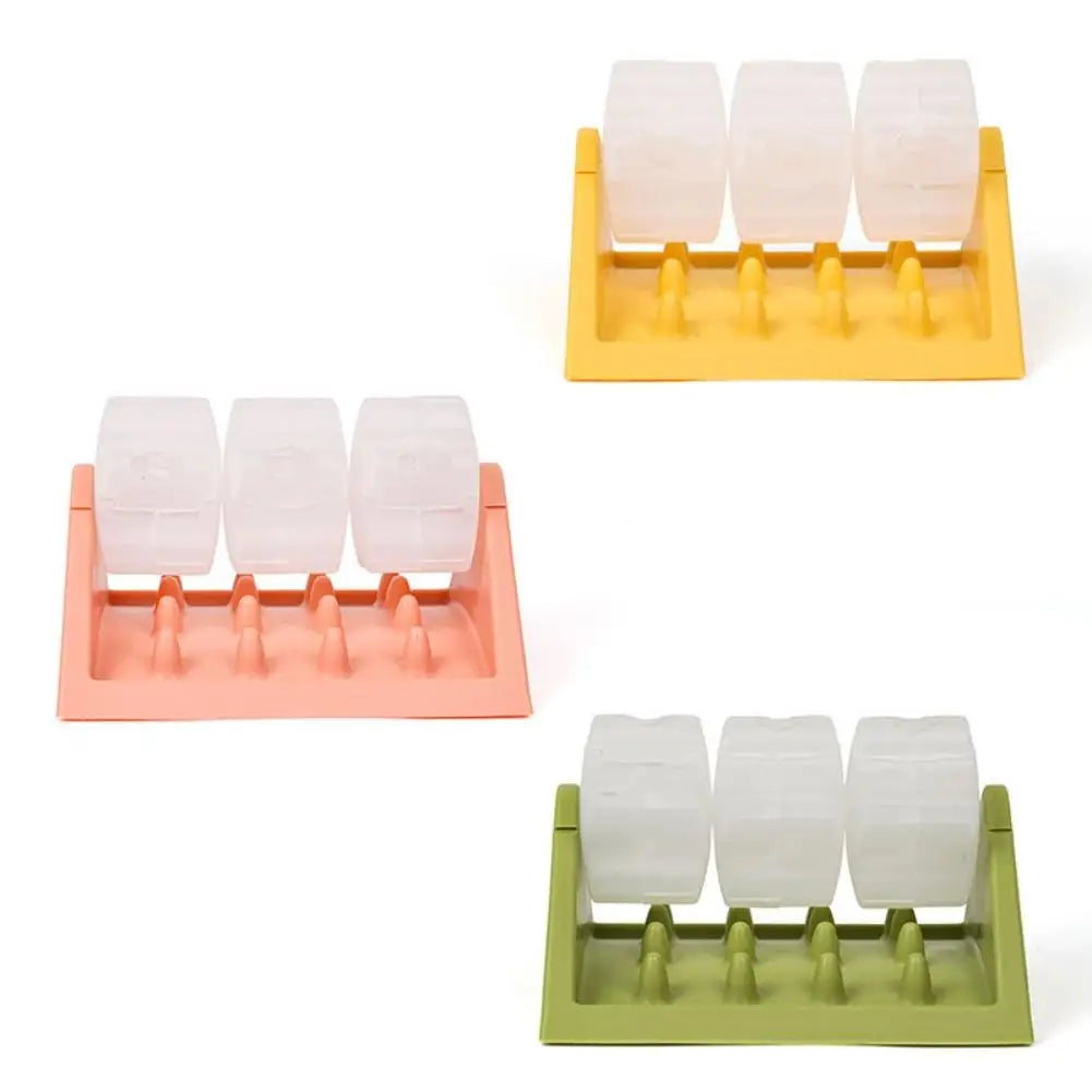 Three dog puzzle feeders in yellow, pink and green, each with three clear rotating treat-dispensing cylinders.