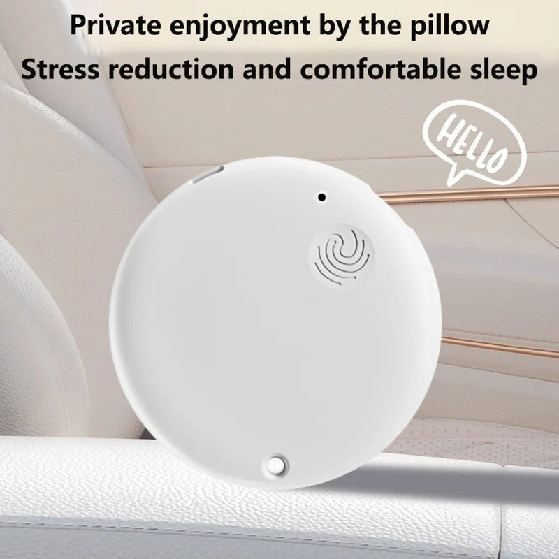 A minimalist, circular white portable Bluetooth speaker featuring a small grill and a hanging loop.