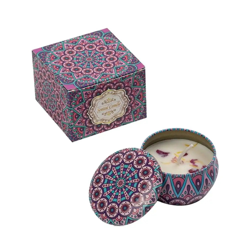 Scented candle in a pink and teal floral tin with matching box, featuring decorative dried petals and a single wick.