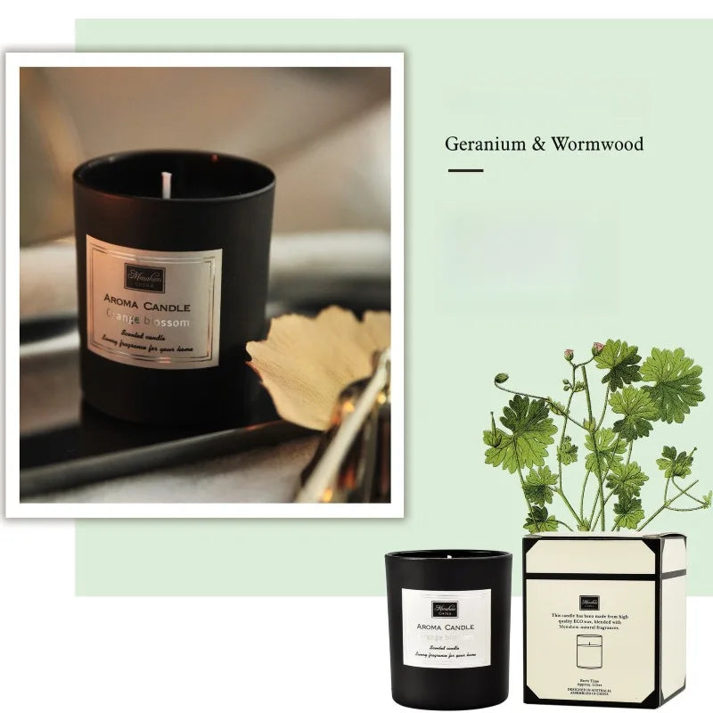 Matte black scented candle with a white label, presented with its decorative gift box and botanical illustration.