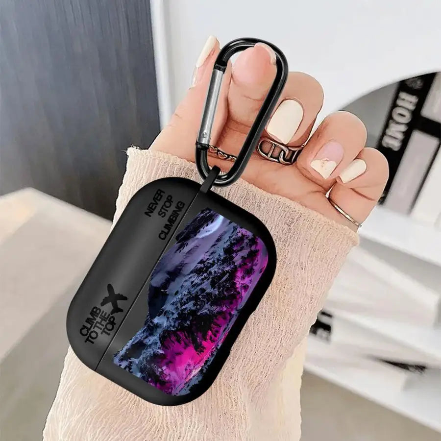 Black silicone AirPods Pro case featuring a "Never Stop Climbing" mountain print and a handy carabiner clip.