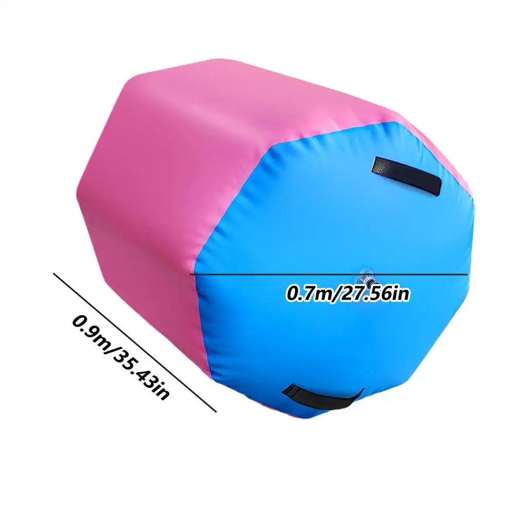 Pink and blue inflatable gymnastics training roller with two black carry handles, showing dimensions of 0.7m x 0.9m.