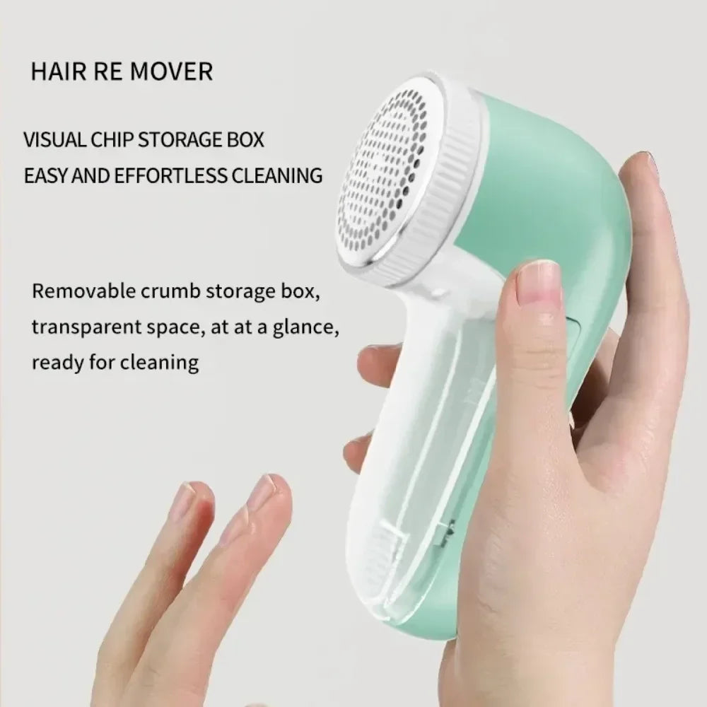 Hand holding a mint green fabric shaver with a transparent lint storage container.
