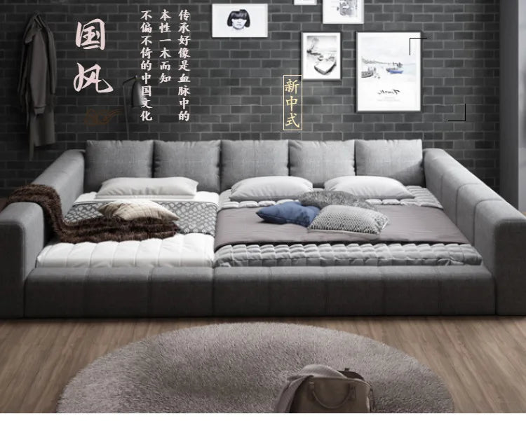 Modern grey fabric 180x200cm double bed featuring a low-profile design, thick padded frame, and cushioned headboard.