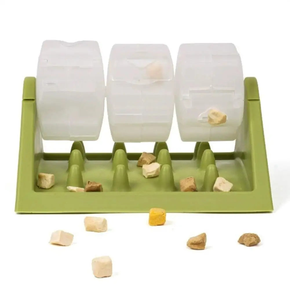 Green interactive dog puzzle feeder with three clear rotating treat chambers and a textured slow-feeder base.