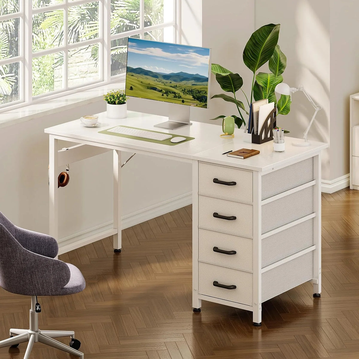 White desk with a computer monitor, plant, and four fabric drawers on the right, set against a window.