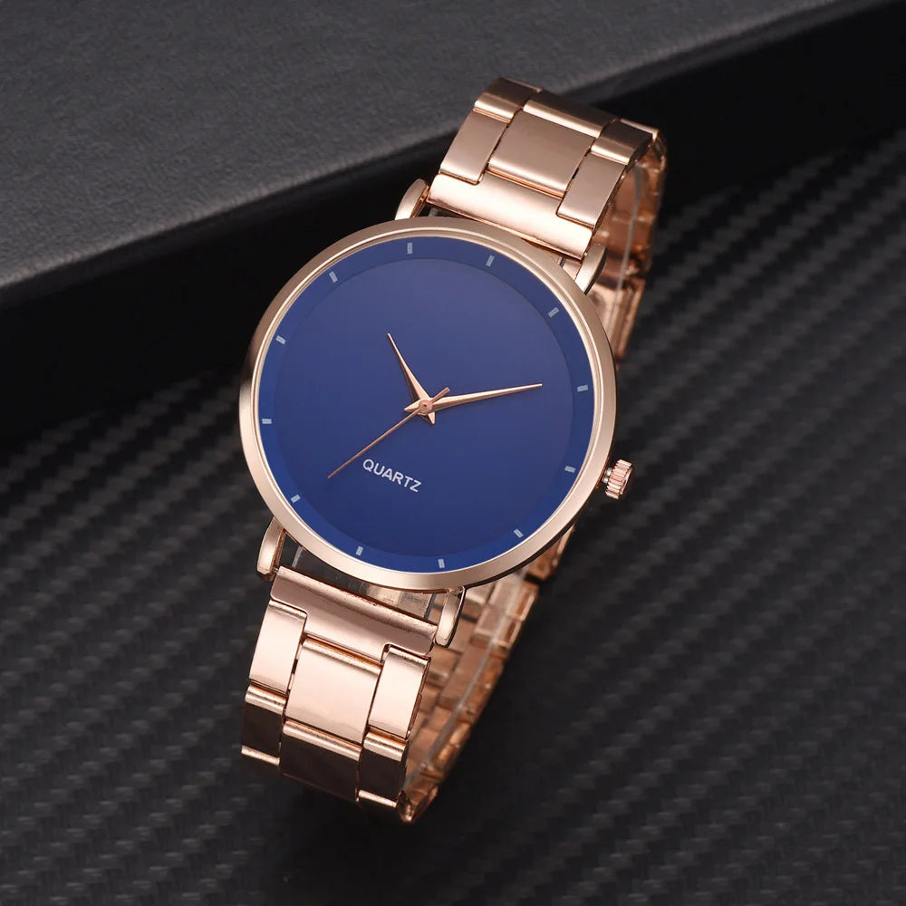 Ladies' watch with a rose gold stainless steel link strap and a minimalist blue round dial with slim rose gold hands.