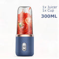 Portable 300ml blue juicer blender with rose gold trim and clear cup containing tomato juice, on white background.