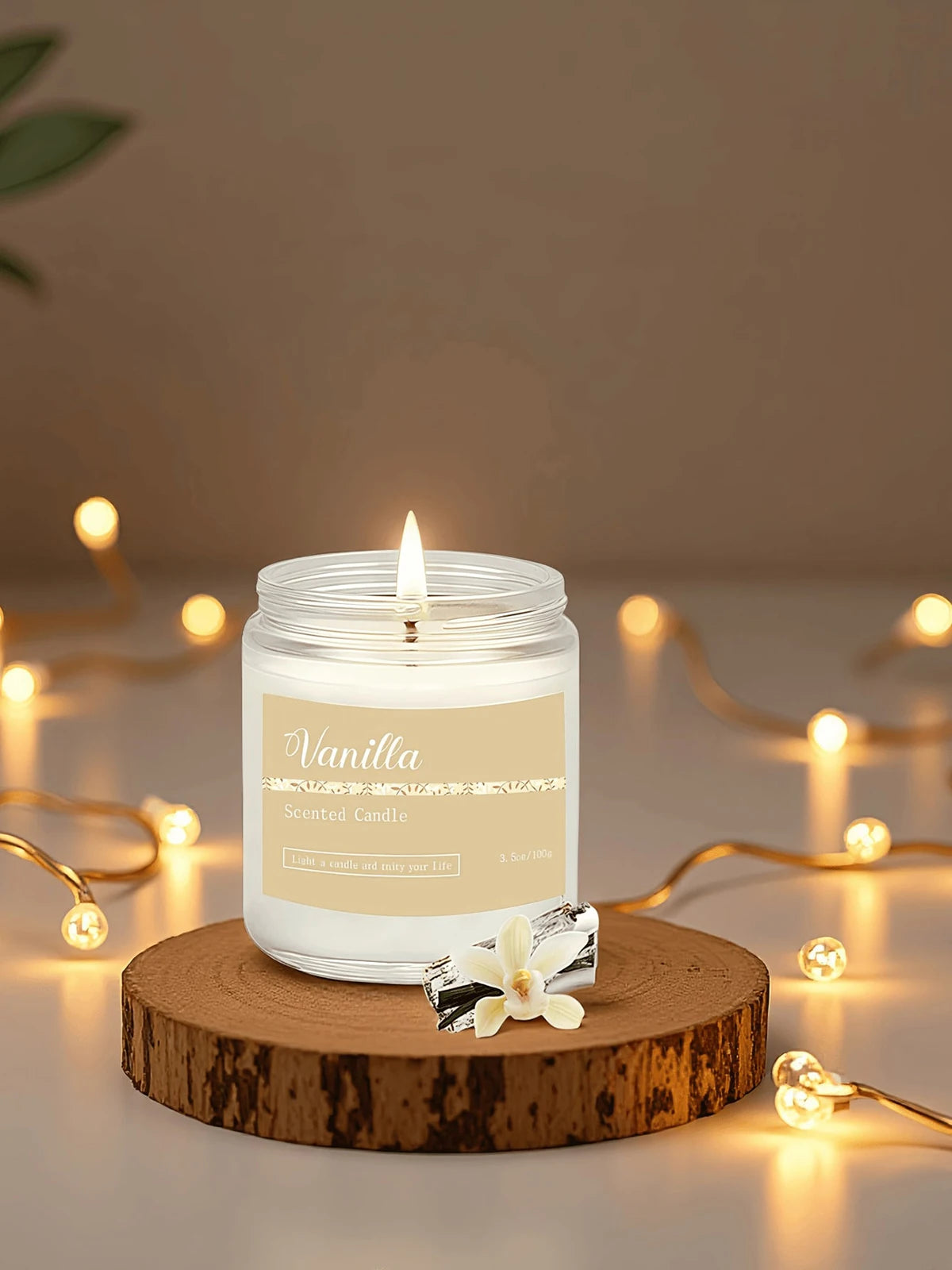 Lit vanilla-scented candle in a glass jar, set on a wooden slice surrounded by warm fairy lights.