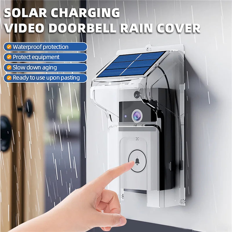 A black and white wireless video doorbell with a clear plastic solar-charging rain cover mounted to a wall.