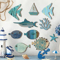Set of handcrafted wooden ocean wall art in blue and white, featuring assorted fish, a boat, coral, and a starfish.