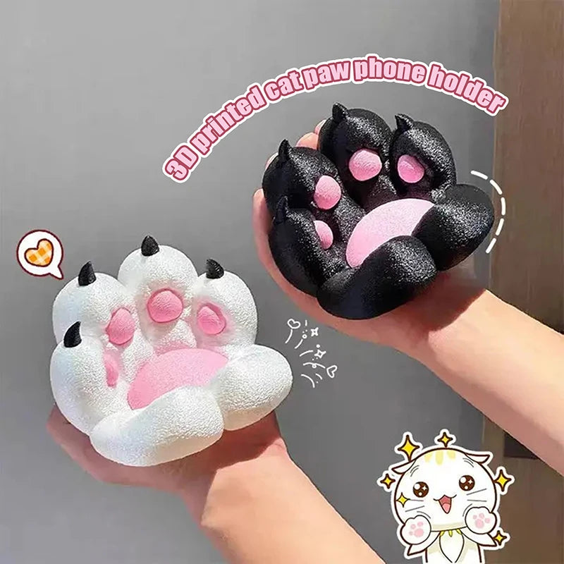 Two 3D printed cat paw phone holders in black and white, featuring textured pads and black claws held in hands.