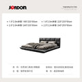 Modern floating king-size bed in black leather, featuring a sleek low-profile frame and a cushioned headboard.