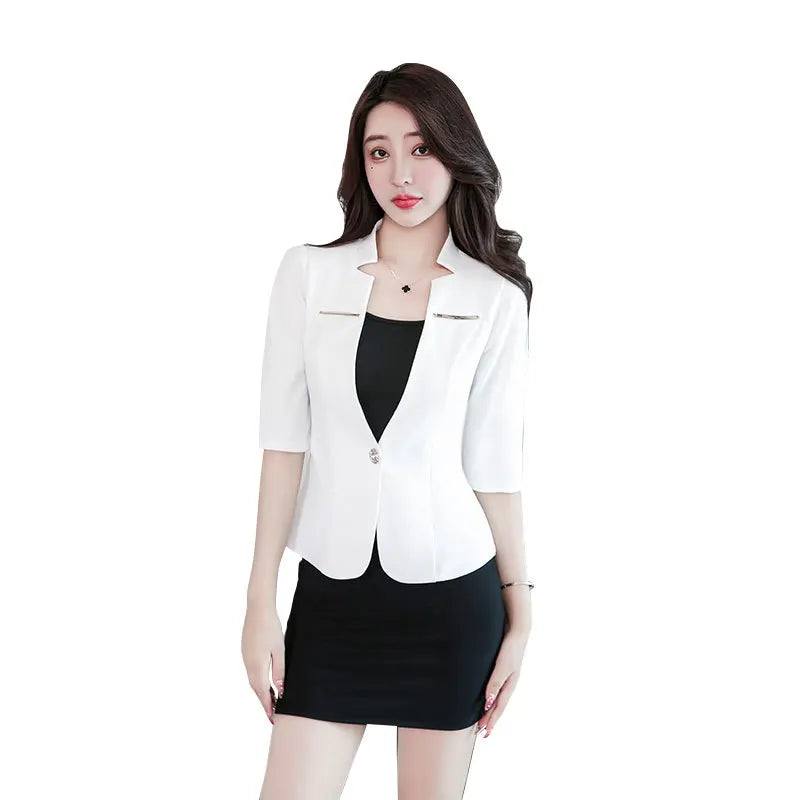 Woman wearing a white, single-button, short-sleeved blazer with a notched neckline over a black mini dress.