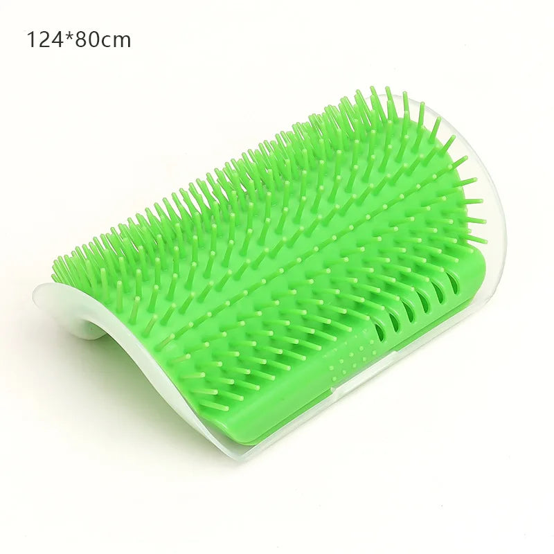 Green curved self-grooming wall brush for cats with flexible silicone bristles on a white base.