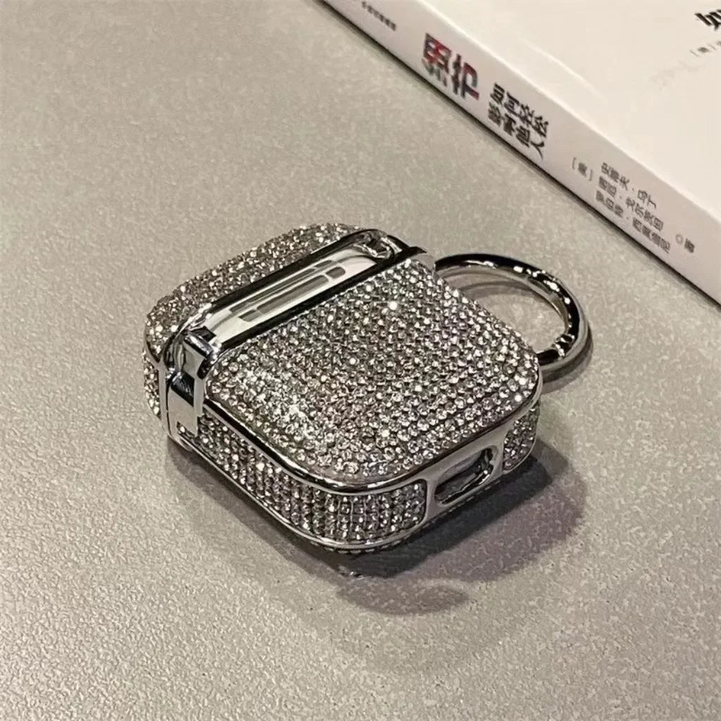 Silver crystal-encrusted AirPods case with a metal keyring attachment. Compatible with standard AirPods models.