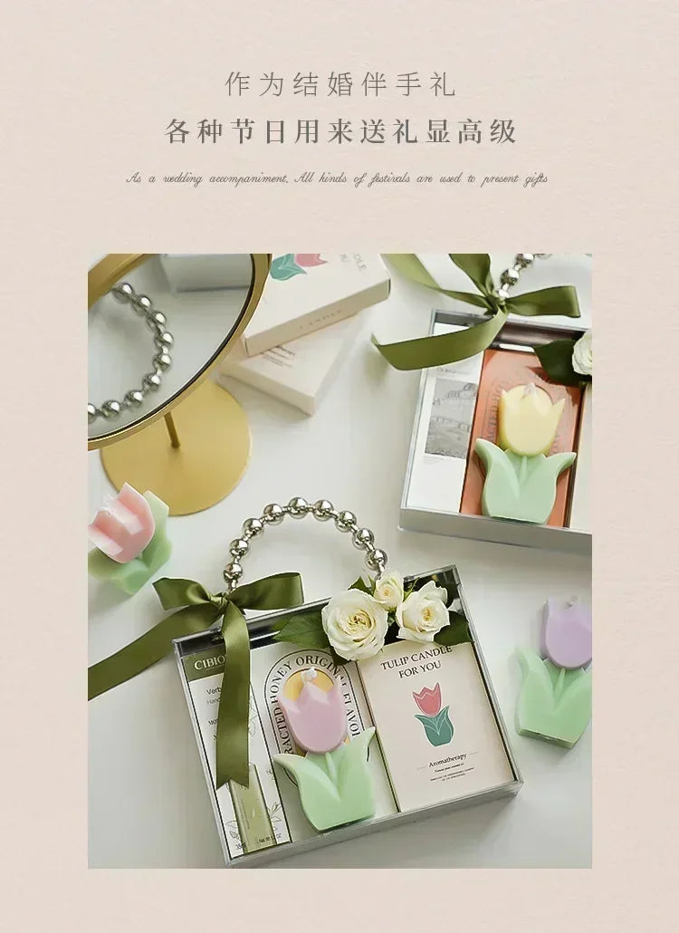 Gift set featuring pastel-coloured tulip candles, a handbag-style box with a beaded handle and green ribbon.