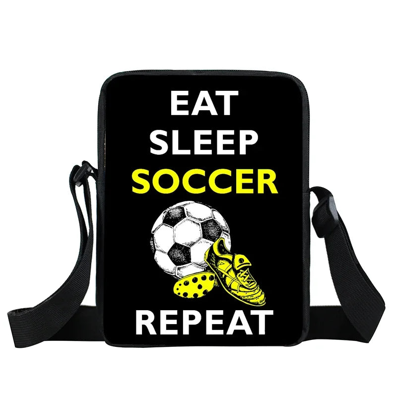 Black crossbody shoulder bag featuring "Eat Sleep Soccer Repeat" text, a football, and a yellow soccer cleat graphic.