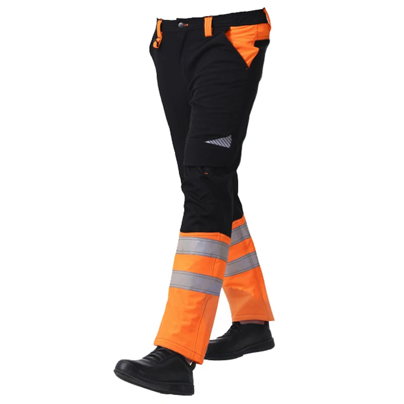 Black and high-vis orange work trousers with reflective strips on the lower legs, shown from the side.