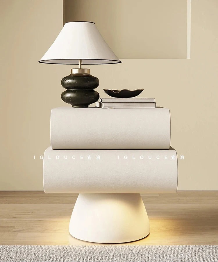 Modern off-white pedestal bedside table with two sleek drawers and a curved, minimalist design.