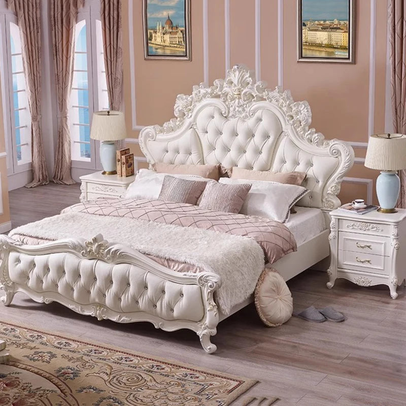 Luxury cream white upholstered princess bed with an ornate carved frame, crystal button tufting, and matching tables.