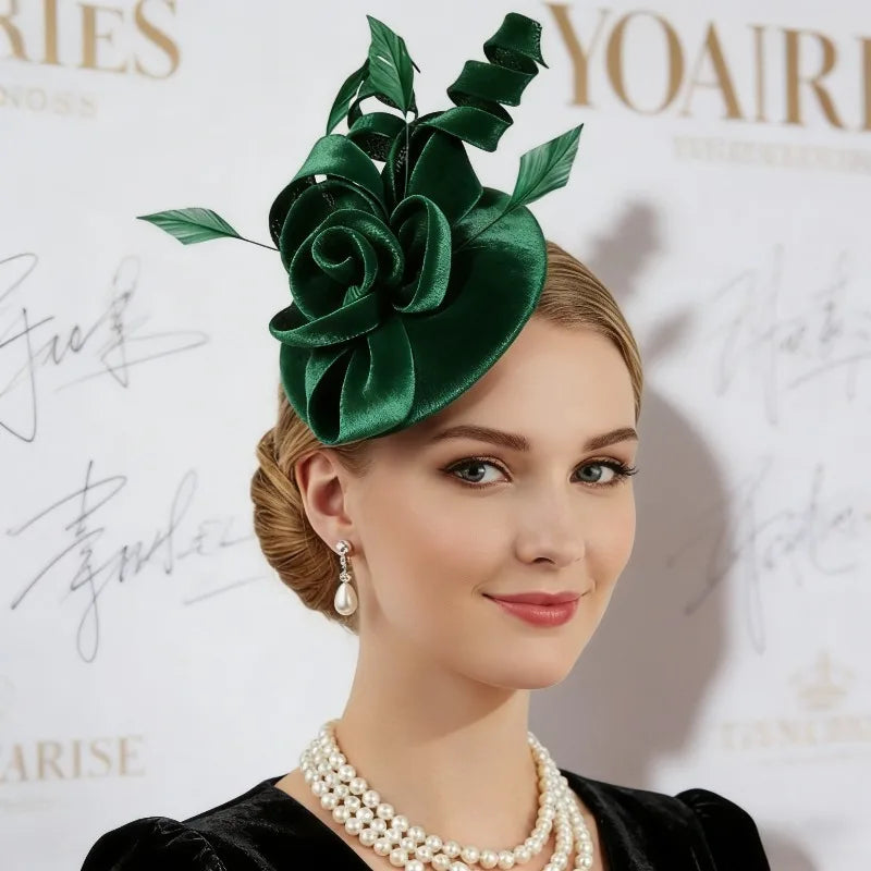 Elegant dark green fascinator featuring a satin rose, swirling ribbon detail, and leaf accents.