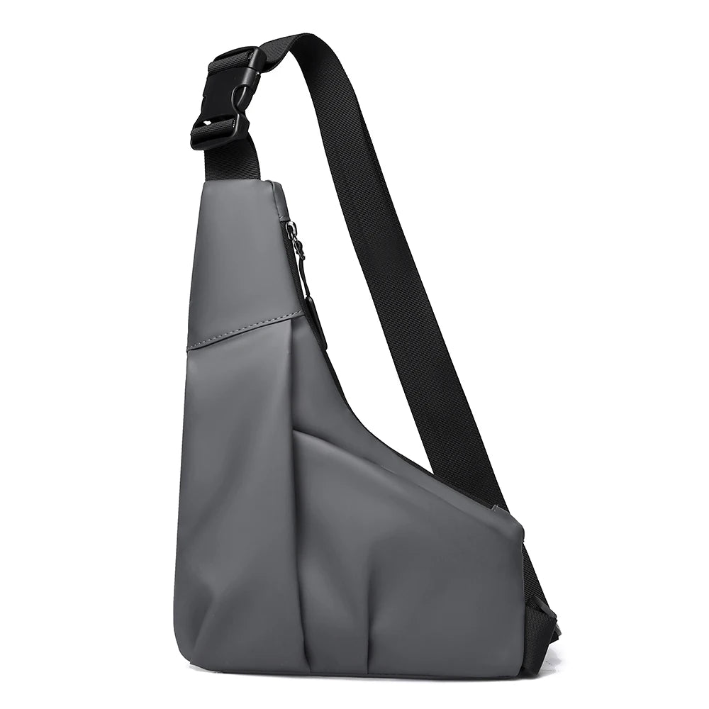 Grey anti-theft triangle crossbody bag with a secure zip, adjustable black strap, and quick-release buckle.