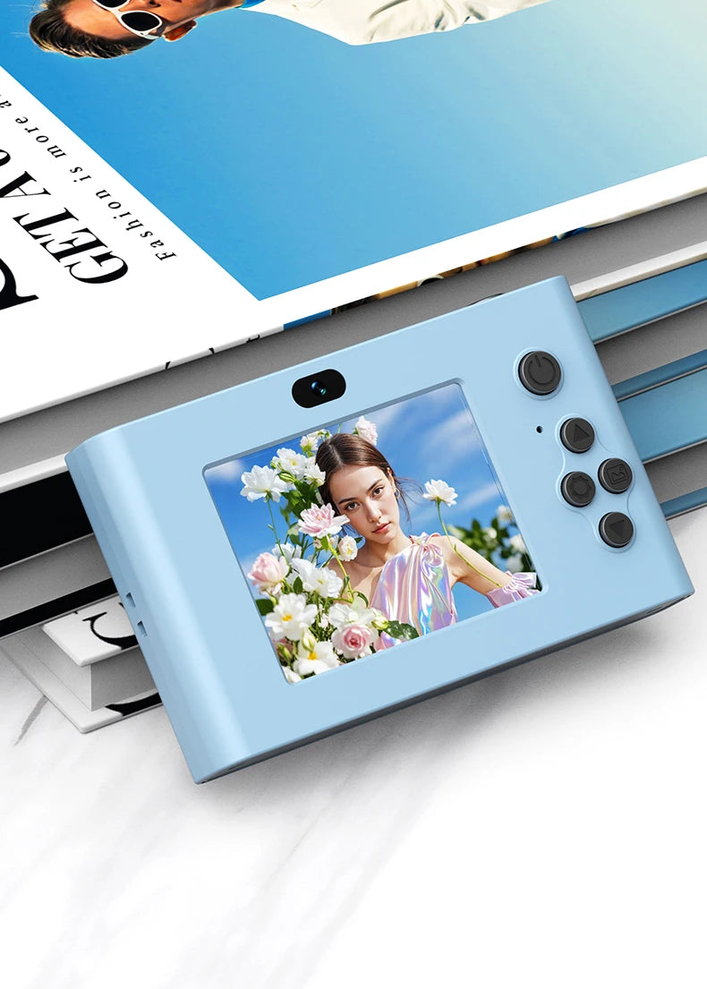 Light blue compact digital camera with a small LCD screen, navigation buttons, and a camera lens.